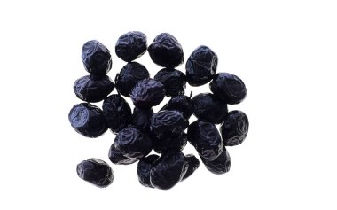 A small pile of black olives with stones isolated on white background