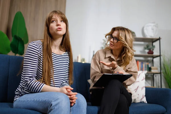 stock image Young depressed woman shares her problems with a psychologist