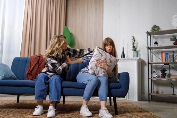 stock image Upset teenager female after quarrel with her mother in home. Woman comforts her daughter