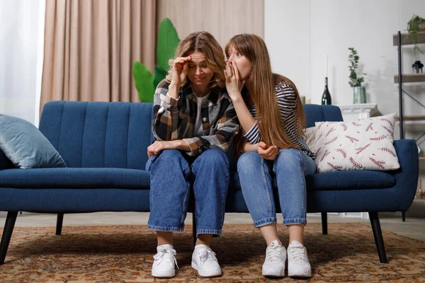 stock image Mature mother is shocked by the news that daughter whispers in her ear