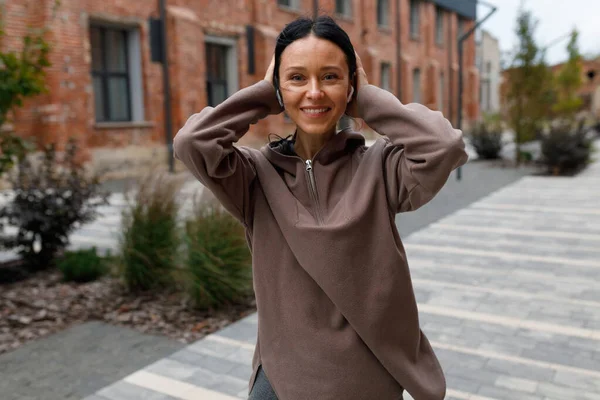 Sportliche Frau Mit Kopfhörern Posiert Auf Der Straße — Stockfoto