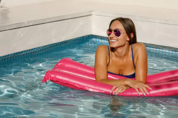 Summer Vibes: Cool Girl on Pink Pool Float