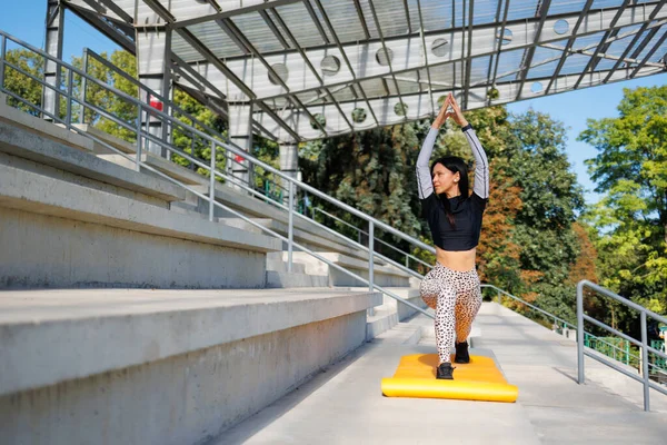 Spor sahasında sporcu yoga antrenmanı.