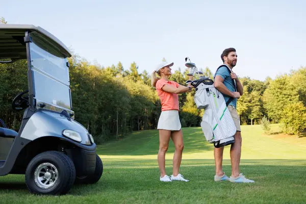 Golf Affection: Woman Choosing Club from Partner\'s Bag