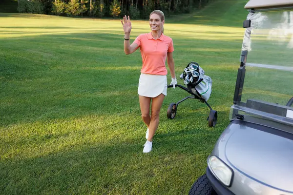 Sporty Woman with Golf Equipment on Lush Course