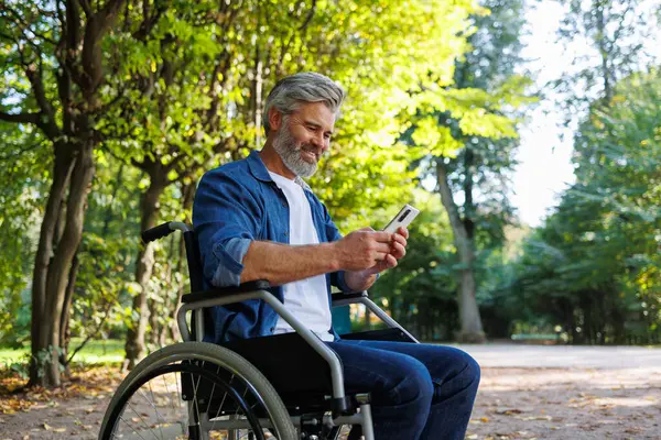 Mobile Independence Użytkownik Wózka Inwalidzkiego Korzystający Parku Smartfonem — Zdjęcie stockowe