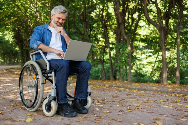 Park Office: Mobility-Challenged Professional with Laptop