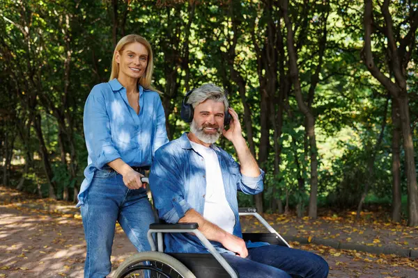 Guided by Sound: Woman Leads Companion in Wheelchair Through Nature