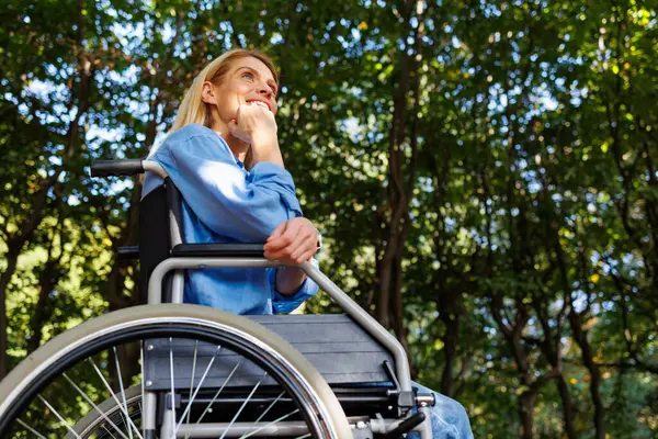 Accessible Enjoyment: Woman in Wheelchair Embraces Nature