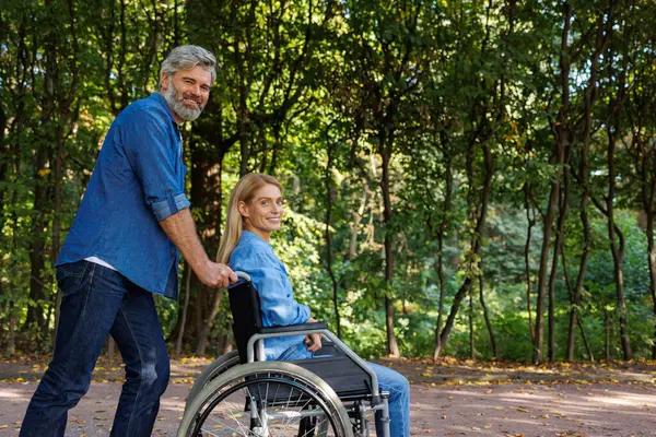 Shared Adventures: Disabled Couple Exploring Park Pathways