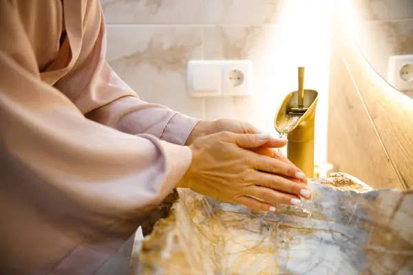 Fresh Start: Young Woman Cleansing in Contemporary Bathroom