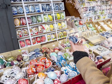 Panayırdaki kadın bayramlık Paskalya yumurtasını hediye olarak seçiyor.