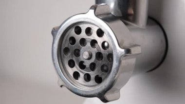 Close up view on Electric meat grinder. Making minced meat in an electric meat grinder from fresh chicken meat at home.