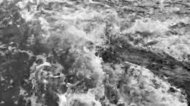 Close up view on stormy gray ocean or sea waves. Top view of Atlantic ocean wave during storm. 4K resolution video.