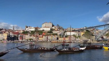 Porto, Portugal - 21.01.2023: Touristic view on the beautiful old town of Porto, river Douro and small bright boats full of tourists for excursion, Portugal travel video