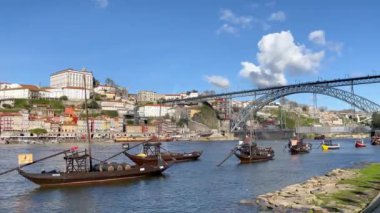 Porto, Portugal - 21.01.2023: Touristic view on the beautiful old town of Porto, river Douro and small bright boats full of tourists for excursion, Portugal travel video