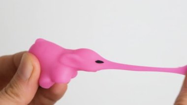 Hands are playing with anti-stress. Close up view on hands play with squash animals. The concept of relieving tension or stress in children and adults. Slow motion full HD video.