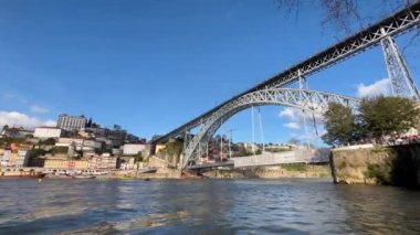 Porto, Portugal - 21.01.2023: Touristic view on the beautiful old town of Porto, river Douro and small bright boats full of tourists for excursion, Portugal travel video