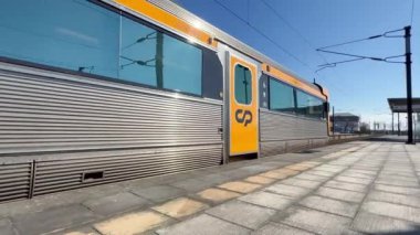 Estarreja, Portugal - 20.02.2023: A high-speed train passes by the station at high speed in Estarreja, Portugal. The train stops at the station and opens the doors