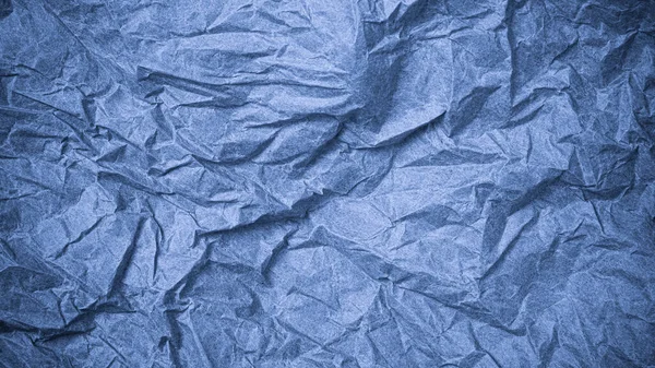 Top view of wrinkled textured paper. Blue crumpled paper texture background. Wrinkled, abstract paper background