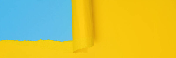 Long banner with ripped paper. Abstract torn Paper banner in yellow and blue colors with copy space. Torn Paper with space for text with blue background.
