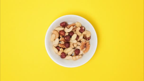 Nuts Filling Bowl Bright Yellow Background Stop Motion Video Cashews — Stock Video