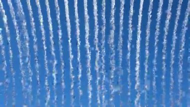 Su akıntılarının parlak mavi gökyüzüne karşı canlı görüntüsü, dinamik, soyut bir şablon yaratıyor doğa veya enerji temalı görseller için ideal.