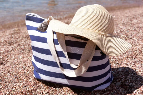 Beach Accessories Bag Sun Hat Pebble Beach Sea Summer Background Stockfoto