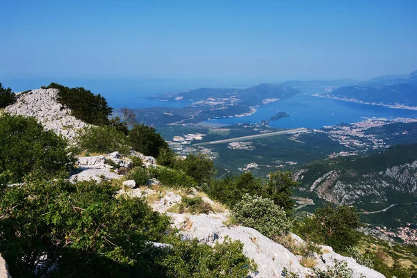 stock image Scenic panoramic view from above of the world famous Bay of Kotor and mountains around, on a beautiful sunny day with blue sky and clouds in summer, Montenegro, southern Europe. Aerial view.