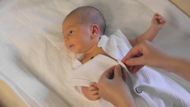 Mother Dressing Her Newborn Baby Indoors Cute Newborn Lies Changing — Stock Video