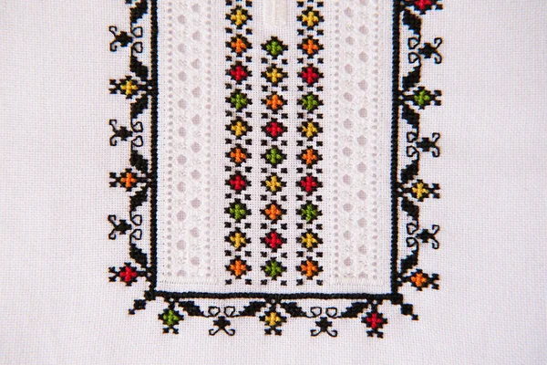 Texture of linen textile with embroidery. Ethnic pattern design. Craft embroidery. Geometric ornament.