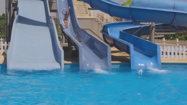 Young Boy Swim Trunks Enjoying Water Slide Outdoor Pool — Stock Video