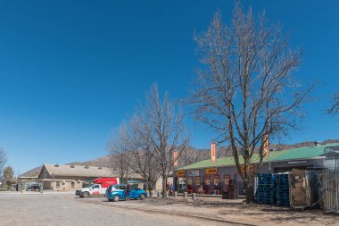 OP DIE BERG, Güney Afrika - SEP 9, 2022: Batı Cape Eyaleti 'nin Koue Bokkkkeveld bölgesindeki Op Die Berg' de süpermarket, araç ve insanlarla dolu bir sokak sahnesi