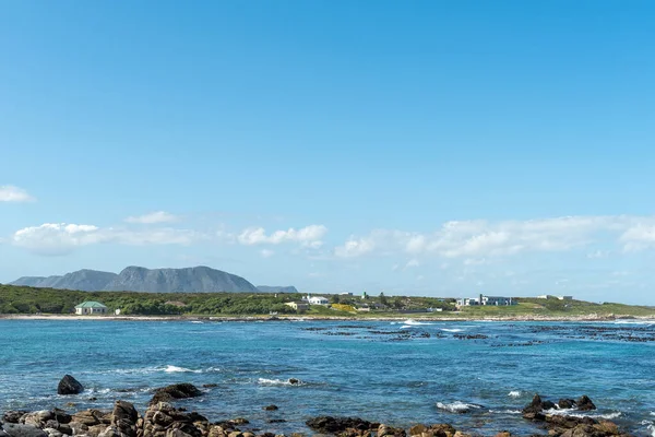 stock image Gansbaai, South Africa - Sep 20, 2022: Buildings are visible across Kruismans Bay near Gansbaai in the Western Cape Province