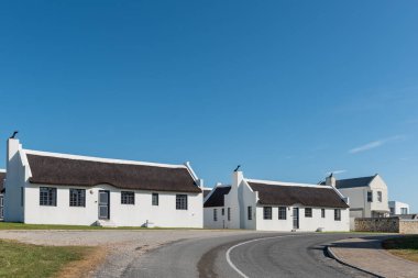 Arniston, Güney Afrika - 22 Ekim 2022 Batı Cape Eyaleti Arniston 'da sazdan çatı evleri olan bir sokak manzarası