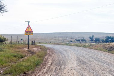 Road from Bredasdorp to the ferry over the Breede River at Malagas in the Western Cape Province. A road sign indicates that the ferry is open