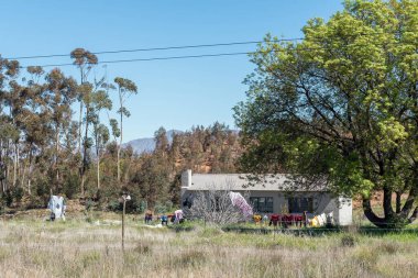 OP DIE BERG, SOUTH AFRICA - SEP 9, 2022: A farm worker house next to road R303 near Op Die Berg in the Koue Bokkeveld region of the Western Cape Province. Laundry are visible
