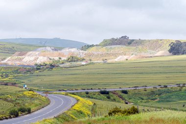 Cape Town, South Africa - Sep 16, 2022: Mine dumps of the Ciolli Bros stone crusher plant and open cast mine at Durbanville Hills in the Western Cape Province.