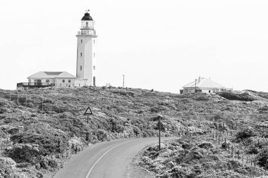 Gansbaai, South Africa - Sep 20, 2022: Danger Point Lighthouse near Gansbaai in the Western Cape Province. Monochrome