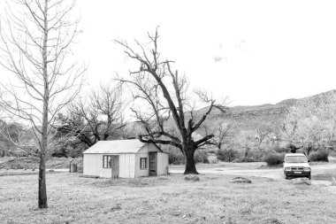 Kromrivier, South Africa - Sep 5, 2022: A corrugated iron building and a vehicle at Kromrivier Cederberg Park in the Western Cape Cederberg. Monochrome