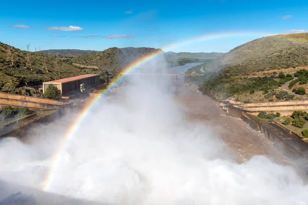 The Gariep Dam overflowing. The dam is the largest in South Africa. It is in the Orange River on the border between the Free State and Eastern Cape Provinces. A rainbow is visible