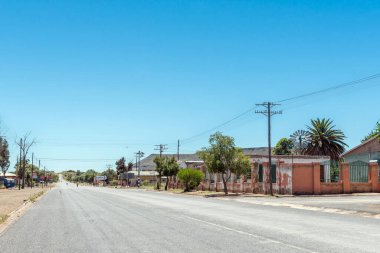 Petrusville, South Africa - Feb 21, 2023: A street scene, with buildings and people, in Petrusville in the Northern Cape Province