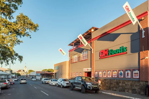 stock image Prieska, South Africa - Feb 28 2023: A street scene, with a supermarket, people, vehicles and a church, in Prieska in the Northern Cape Province