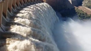 The Gariep Dam overflowing. The dam is the largest in South Africa. It is in the Orange River on the border between the Free State and Eastern Cape Provinces. A rainbow is visible