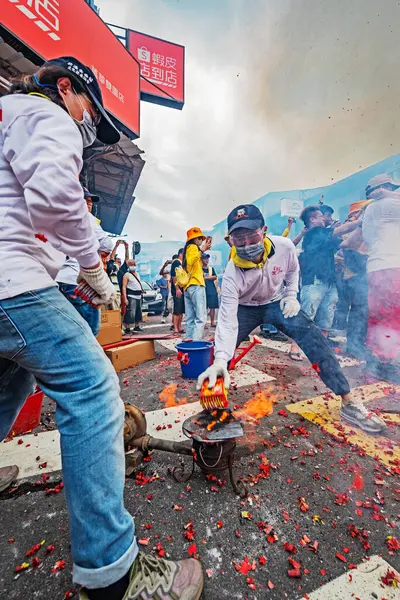 stock image Taipei, Taiwan - July 21,2024 : The li-pow in the temple fairli-pow refers to using a stove to heat the pig iron sheets of the plowshare at high temperature, then lighting the cannon in a streaking manner and throwing it under the mikoshi. 