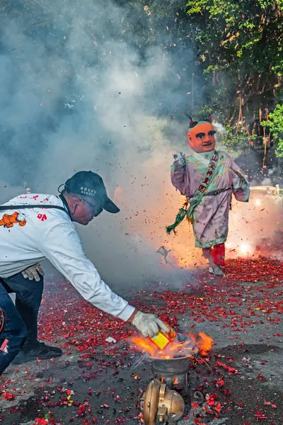 stock image Taipei, Taiwan - July 21,2024 : The li-pow in the temple fairli-pow refers to using a stove to heat the pig iron sheets of the plowshare at high temperature, then lighting the cannon in a streaking manner and throwing it under the mikoshi. 