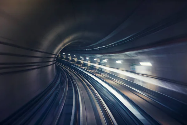 Railroad track in underground tunnel in blurred motion. Point of view from train.