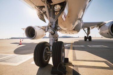 Low angle view of airplane at airport. Preparation passenger plane before flight during sunny summer day clipart