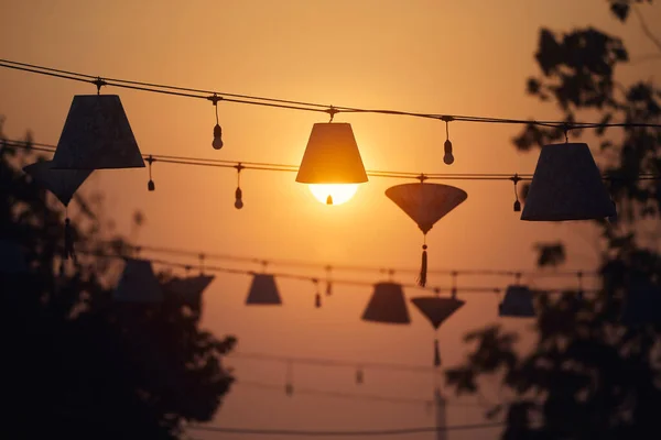 stock image Traditional lanterns hanging above the street in Hoi An in Vietnam. The sun looking like bulb in lamp