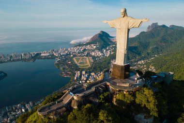 Rio de Janeiro, Brazil - March 21, 2023: Christ the Redeemer statue on top of the Corcovado mountain with Rodrigo de Freitas lagoon below. clipart